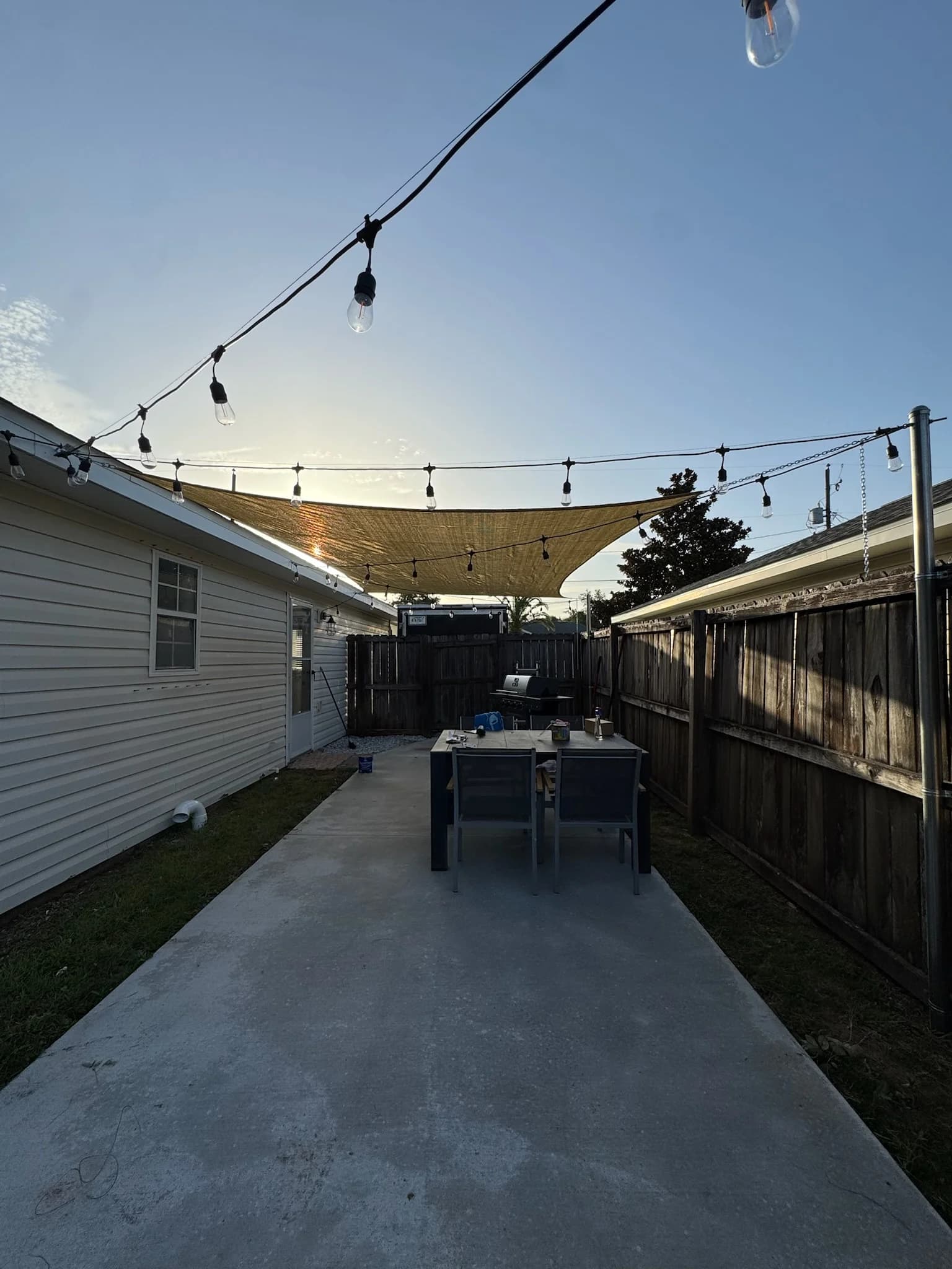Outdoor dining under string lights at the Tiny Tides cottage